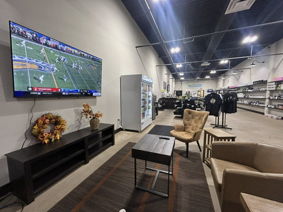 The customer lounge at the SuppLife Bristol, CT store with leather chairs and a TV